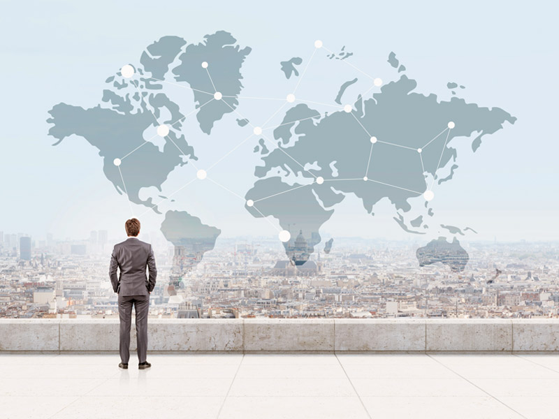 Businessman looking at world map